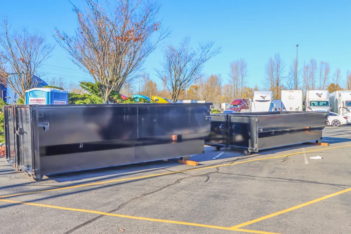 Professional dumpster rental service with roll-off container on residential driveway in Wrentham